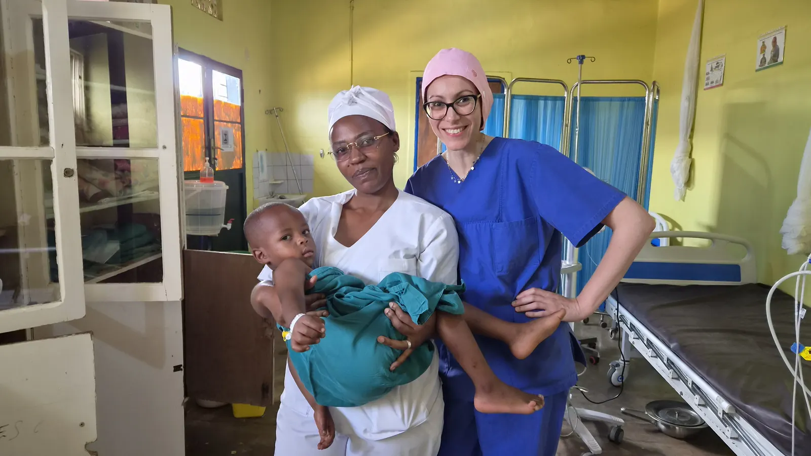 Two members of staff with a young patient in the recovery room of Remera-Rukoma Hospital